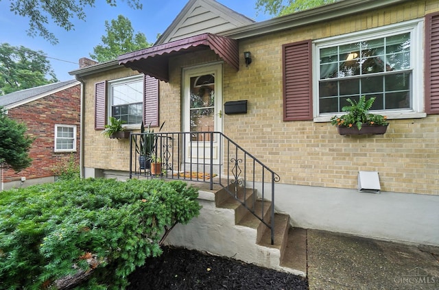 1146 Wilshire Ave, Anderson Twp, OH 45230 - view of exterior entry with brick siding and a chimney