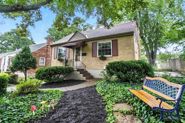 1146 Wilshire Ave, Anderson Twp, OH 45230 - view of front of property featuring a chimney, brick siding, and roof with shingles