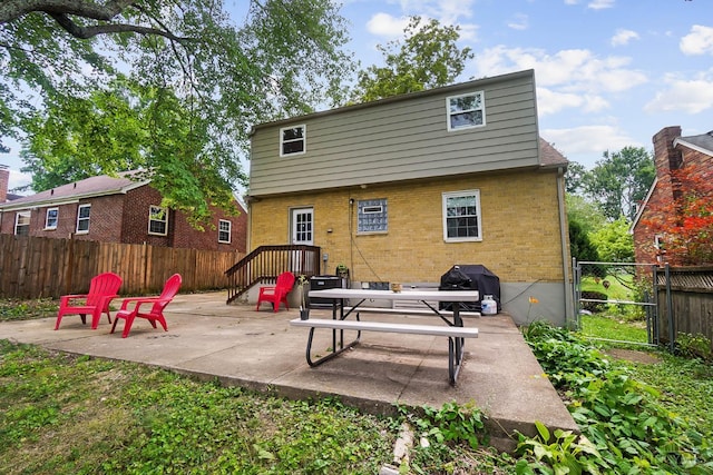 1146 Wilshire Ave, Anderson Twp, OH 45230 - back of house featuring brick siding and a patio area
