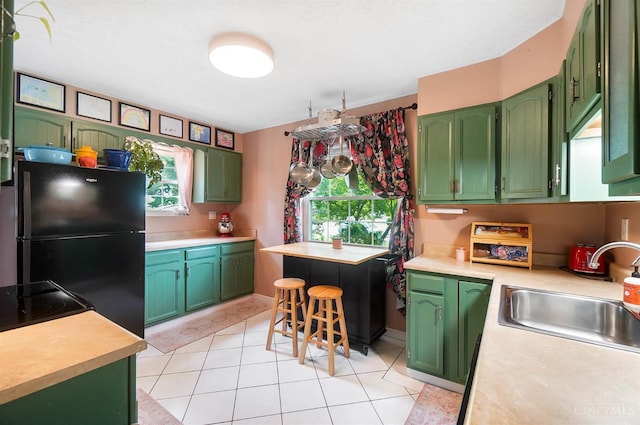 1146 Wilshire Ave, Anderson Twp, OH 45230 - kitchen featuring freestanding refrigerator, green cabinetry, light countertops, and light tile patterned flooring