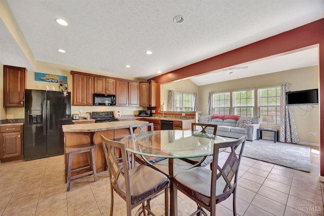 8020 Stoney Ridge Dr, Colerain Twp, OH 45247 - dining room with recessed lighting, light tile patterned flooring, vaulted ceiling, and a textured ceiling