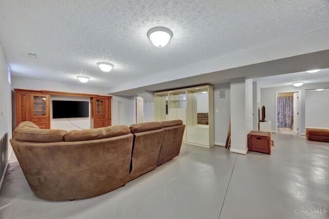 8020 Stoney Ridge Dr, Colerain Twp, OH 45247 - living area featuring finished concrete floors and a textured ceiling