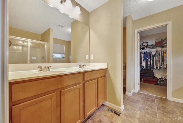 8020 Stoney Ridge Dr, Colerain Twp, OH 45247 - full bathroom featuring a stall shower, double vanity, and a walk in closet