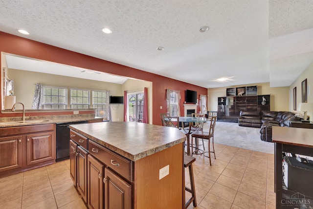 8020 Stoney Ridge Dr, Colerain Twp, OH 45247 - kitchen with black dishwasher, a kitchen bar, a textured ceiling, a center island, and light tile patterned flooring