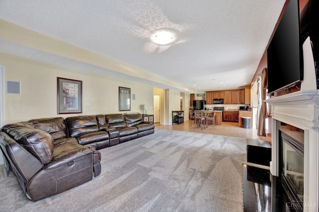 8020 Stoney Ridge Dr, Colerain Twp, OH 45247 - living room with a textured ceiling, light carpet, and a fireplace with flush hearth
