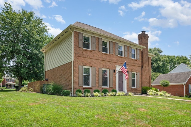 2201 Candlemaker Dr, Anderson Twp, OH 45244 - view of front of house featuring a chimney, a front yard, and brick siding