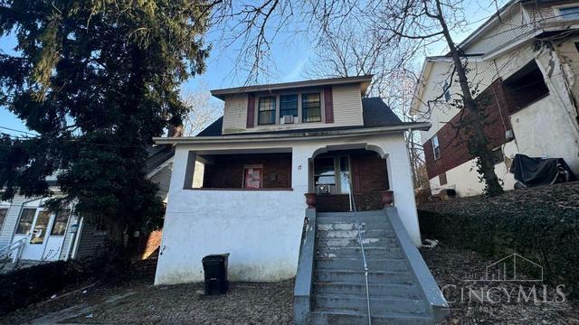 17 Clinton Springs Ln, Cincinnati, OH 45217 - bungalow featuring covered porch, stucco siding, and stairway