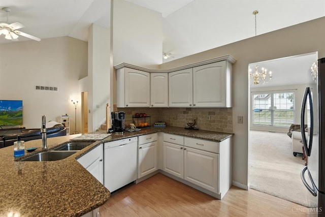 1287 Mcguffey Ln, Union Twp, OH 45103 - kitchen with dishwasher, decorative backsplash, freestanding refrigerator, light wood finished floors, and dark stone counters