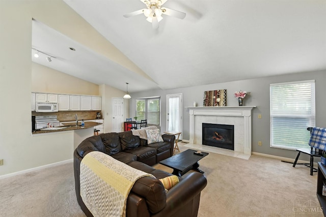 1287 Mcguffey Ln, Union Twp, OH 45103 - living room featuring light carpet, a ceiling fan, a tiled fireplace, and lofted ceiling