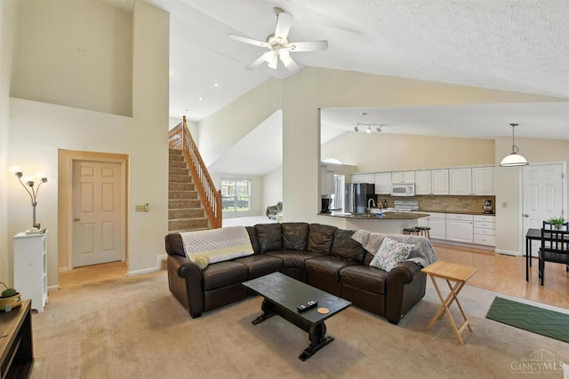 1287 Mcguffey Ln, Union Twp, OH 45103 - living room with stairs, a ceiling fan, and high vaulted ceiling