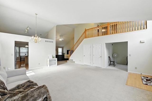 1287 Mcguffey Ln, Union Twp, OH 45103 - unfurnished living room featuring stairway, high vaulted ceiling, a chandelier, a ceiling fan, and carpet flooring
