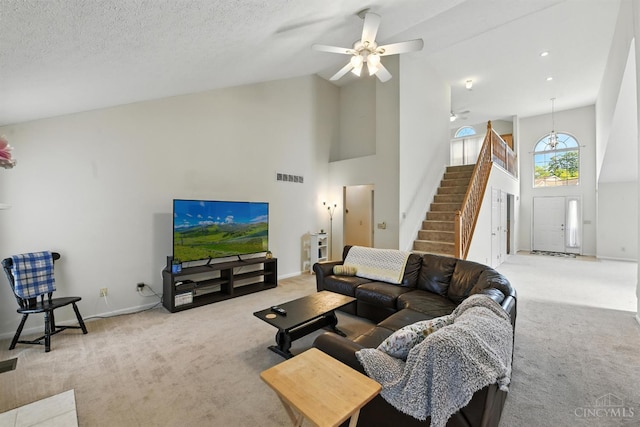 1287 Mcguffey Ln, Union Twp, OH 45103 - carpeted living room featuring high vaulted ceiling, stairway, and ceiling fan