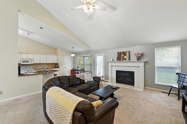 1287 Mcguffey Ln, Union Twp, OH 45103 - living room featuring light colored carpet, a ceiling fan, a fireplace, and vaulted ceiling