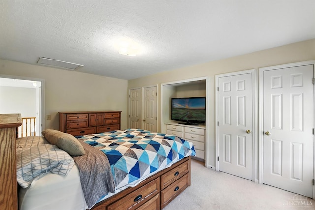 1287 Mcguffey Ln, Union Twp, OH 45103 - bedroom featuring multiple closets, light carpet, attic access, and a textured ceiling