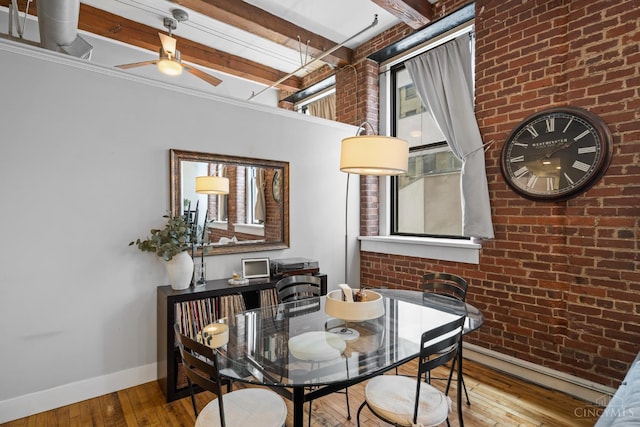 26 E Sixth St Unit 403, Cincinnati, OH 45202 - dining area featuring brick wall, hardwood / wood-style flooring, beam ceiling, and a ceiling fan