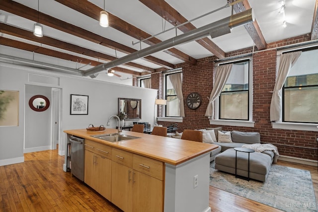 26 E Sixth St Unit 403, Cincinnati, OH 45202 - kitchen with brick wall, dishwasher, wood counters, beam ceiling, and light wood finished floors