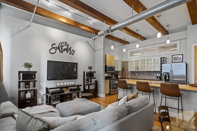 26 E Sixth St Unit 403, Cincinnati, OH 45202 - living room with beam ceiling, a high ceiling, and light wood-type flooring