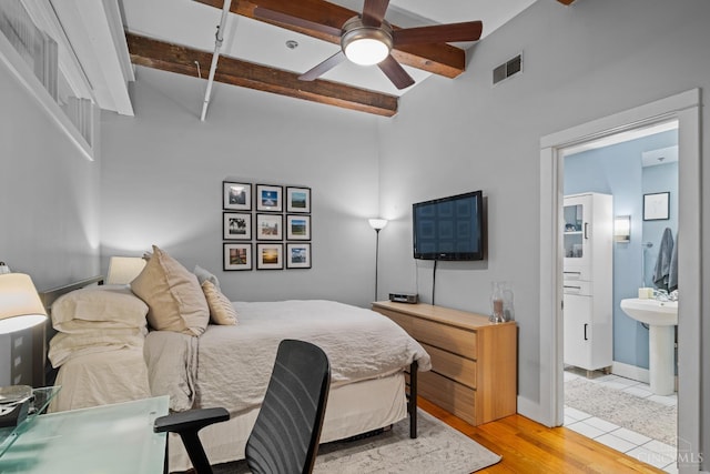 26 E Sixth St Unit 403, Cincinnati, OH 45202 - bedroom featuring beamed ceiling, connected bathroom, light wood finished floors, and a ceiling fan
