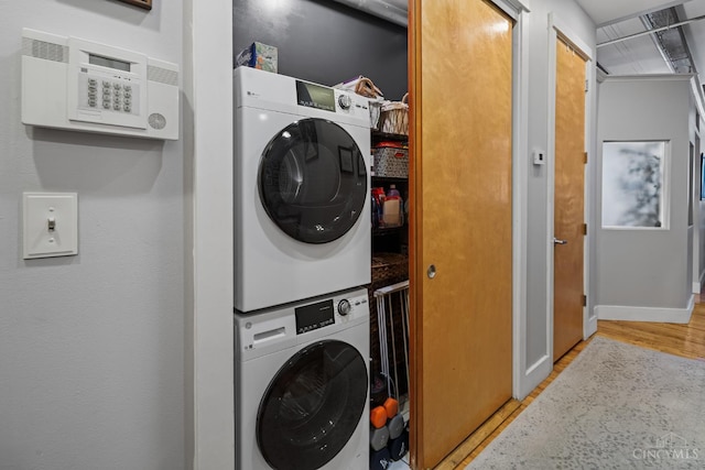 26 E Sixth St Unit 403, Cincinnati, OH 45202 - laundry area with stacked washing machine and dryer and wood finished floors