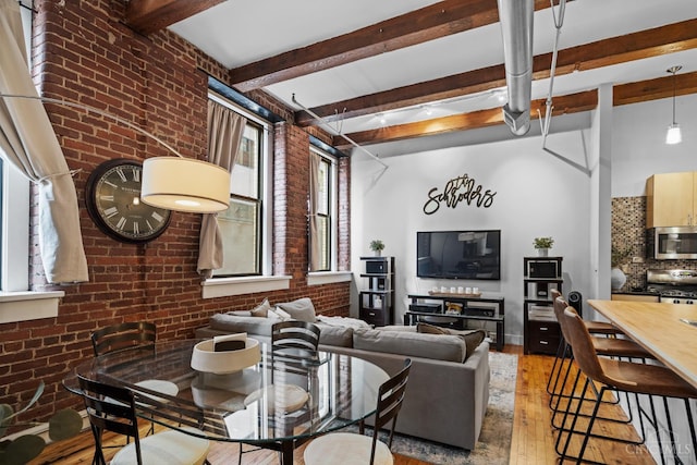 26 E Sixth St Unit 403, Cincinnati, OH 45202 - living area featuring hardwood / wood-style flooring, brick wall, and beam ceiling