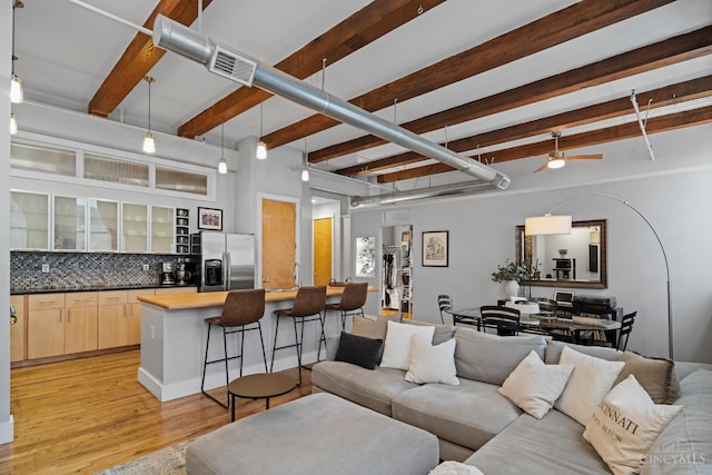 26 E Sixth St Unit 403, Cincinnati, OH 45202 - living area featuring beam ceiling, a ceiling fan, and light wood finished floors