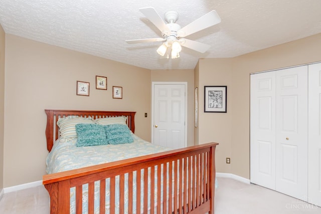 2220 Sulky Ct, Beavercreek Twp, OH 45434 - bedroom with a closet, light carpet, a textured ceiling, and a ceiling fan