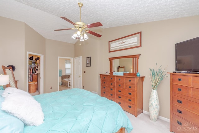 2220 Sulky Ct, Beavercreek Twp, OH 45434 - bedroom featuring lofted ceiling, light carpet, a walk in closet, ensuite bath, and a textured ceiling