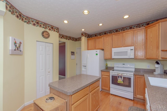 2220 Sulky Ct, Beavercreek Twp, OH 45434 - kitchen featuring white appliances, light wood-style floors, recessed lighting, a center island, and a textured ceiling
