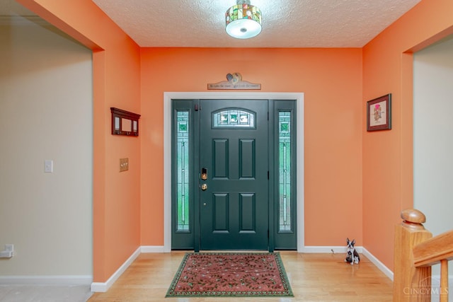 2220 Sulky Ct, Beavercreek Twp, OH 45434 - entryway featuring light wood-style floors and a textured ceiling