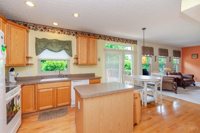2220 Sulky Ct, Beavercreek Twp, OH 45434 - kitchen featuring white appliances, a textured ceiling, light wood-style flooring, a center island, and recessed lighting