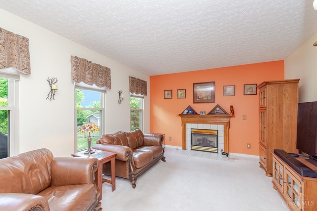 2220 Sulky Ct, Beavercreek Twp, OH 45434 - living room featuring a tiled fireplace, light colored carpet, and a textured ceiling