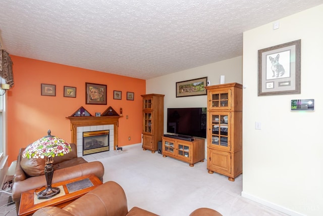 2220 Sulky Ct, Beavercreek Twp, OH 45434 - living room featuring a tile fireplace, a textured ceiling, and light carpet