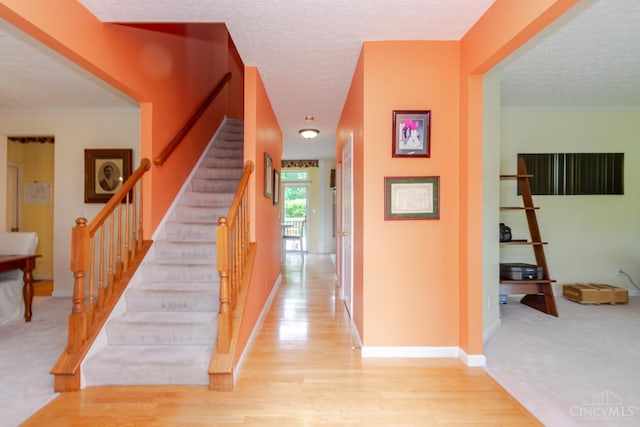 2220 Sulky Ct, Beavercreek Twp, OH 45434 - stairs featuring a textured ceiling and wood finished floors