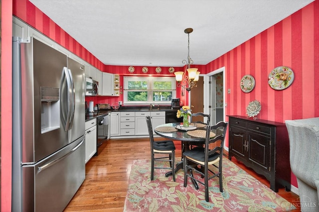 5613 Williamsburg Way, Fairfield, OH 45014 - dining space featuring wallpapered walls, light wood-type flooring, and a chandelier