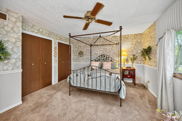 5613 Williamsburg Way, Fairfield, OH 45014 - carpeted bedroom with wallpapered walls, a textured ceiling, multiple closets, and ceiling fan