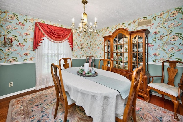 5613 Williamsburg Way, Fairfield, OH 45014 - dining area featuring wallpapered walls, a chandelier, wood finished floors, and a textured ceiling