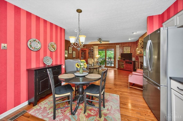 5613 Williamsburg Way, Fairfield, OH 45014 - dining space with wallpapered walls, a chandelier, light wood-style flooring, and a textured ceiling