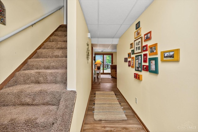 5613 Williamsburg Way, Fairfield, OH 45014 - hallway featuring wood finished floors, a paneled ceiling, and stairway