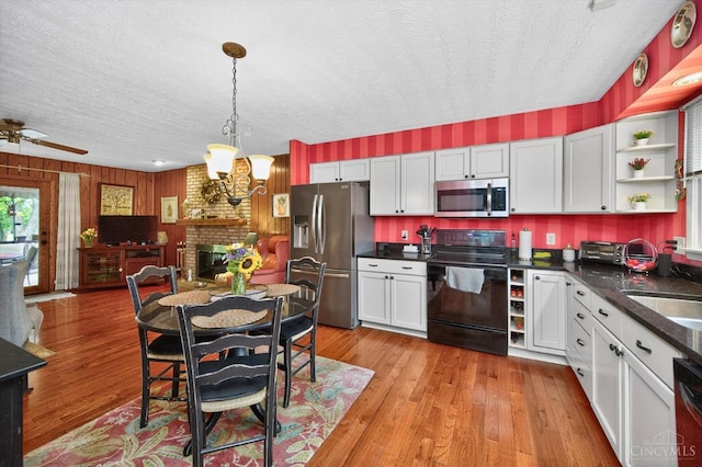 5613 Williamsburg Way, Fairfield, OH 45014 - kitchen with stainless steel appliances, open shelves, a textured ceiling, dark countertops, and open floor plan