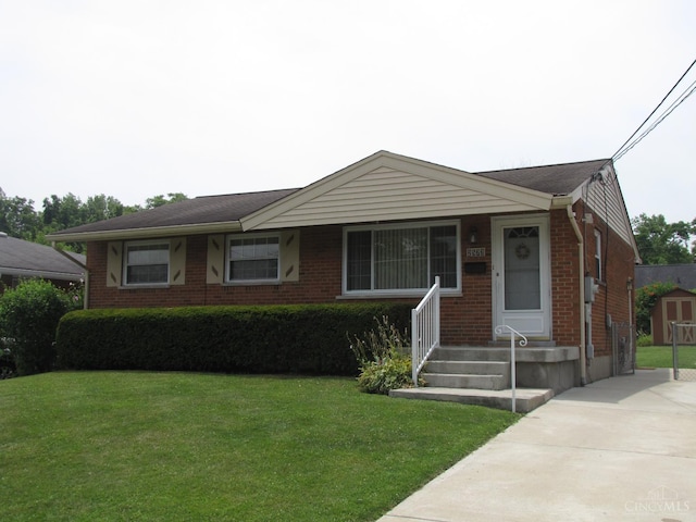 2573 Adams Rd, Colerain Twp, OH 45231 - view of front of property featuring brick siding, a front lawn, and an outbuilding