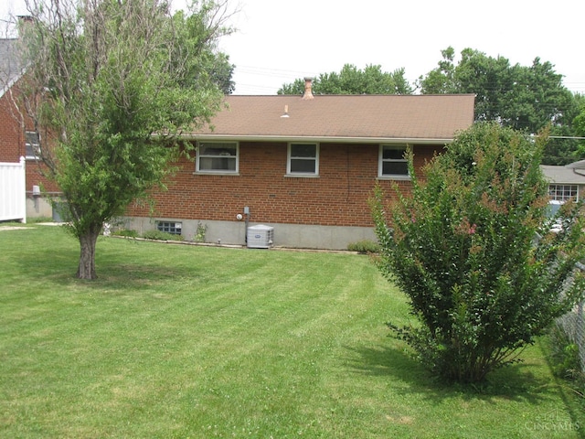 2573 Adams Rd, Colerain Twp, OH 45231 - rear view of house featuring a lawn and brick siding