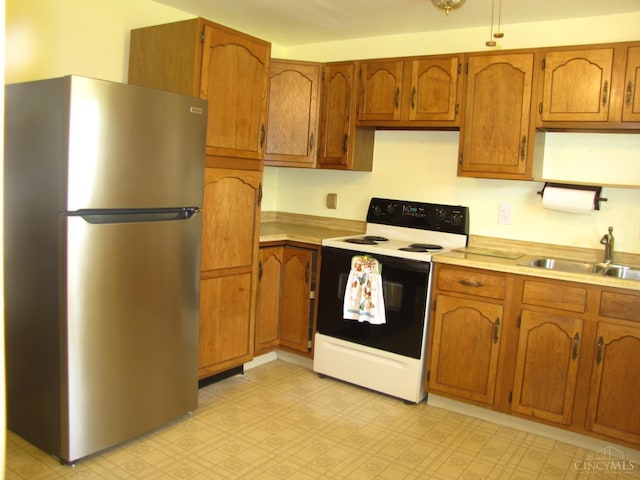 2573 Adams Rd, Colerain Twp, OH 45231 - kitchen with freestanding refrigerator, electric stove, and brown cabinetry