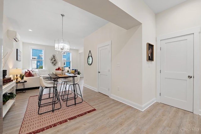 4249 Chambers St, Cincinnati, OH 45223 - dining room with a wall mounted AC, light wood-style flooring, a chandelier, and recessed lighting