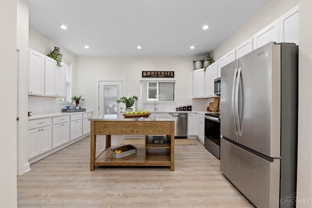 4249 Chambers St, Cincinnati, OH 45223 - kitchen with appliances with stainless steel finishes, light countertops, white cabinets, light wood-style flooring, and recessed lighting