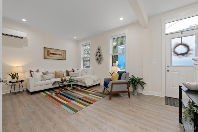 4249 Chambers St, Cincinnati, OH 45223 - living room featuring an AC wall unit, light wood-style floors, and recessed lighting