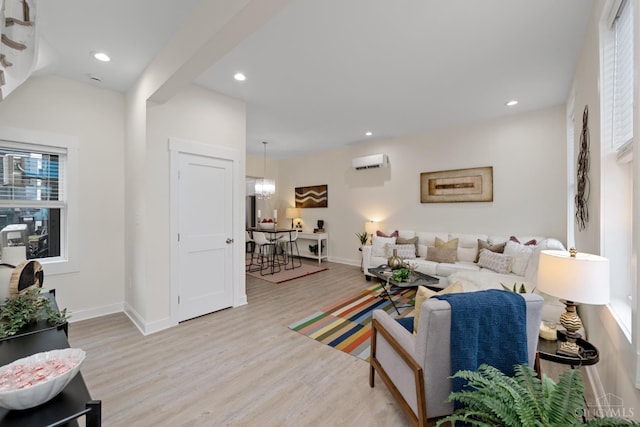 4249 Chambers St, Cincinnati, OH 45223 - living area featuring light wood-style floors, an AC wall unit, recessed lighting, and a chandelier