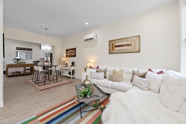 4249 Chambers St, Cincinnati, OH 45223 - living room featuring an AC wall unit, wood finished floors, recessed lighting, and a chandelier