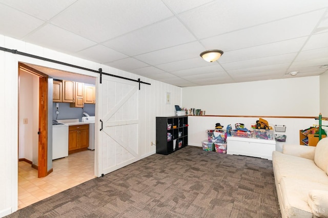 8558 High Trail Ct, Deerfield Twp, OH 45040 - carpeted living room with a barn door, a paneled ceiling, and washer / dryer