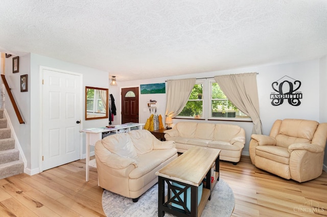 8558 High Trail Ct, Deerfield Twp, OH 45040 - living area featuring light wood-style flooring, a textured ceiling, and stairs