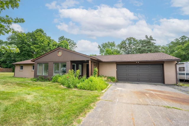 3918 Michael Dr, Union Twp, OH 45255 - view of front facade featuring driveway, a front lawn, an attached garage, and brick siding